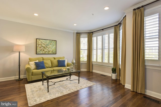 living room with ornamental molding, dark hardwood / wood-style floors, and a healthy amount of sunlight