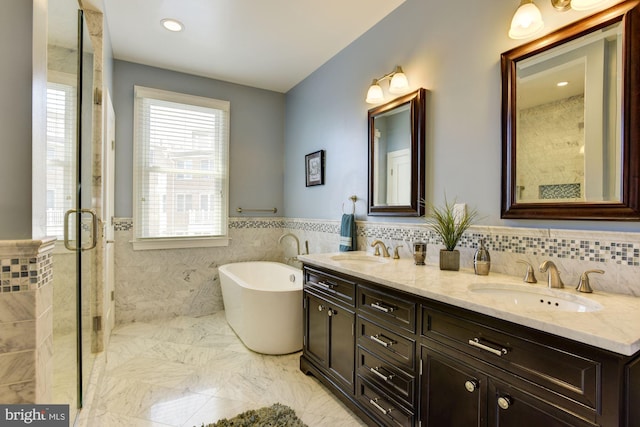 bathroom featuring vanity, tile walls, and independent shower and bath