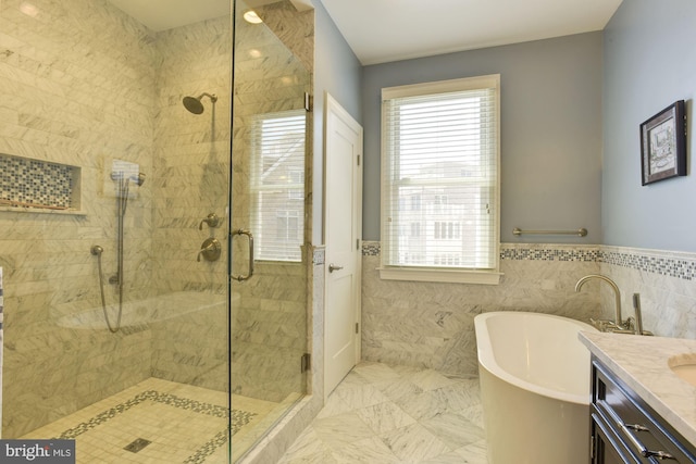 bathroom featuring vanity, tile walls, and plus walk in shower