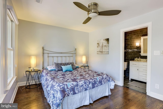 bedroom featuring dark wood-type flooring, ceiling fan, and ensuite bath