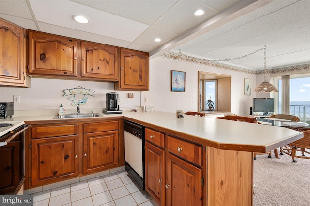 kitchen featuring white appliances, sink, kitchen peninsula, pendant lighting, and light tile patterned floors