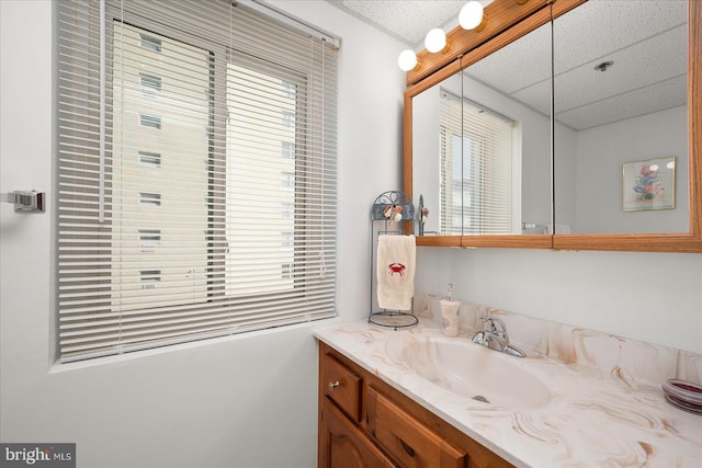 bathroom with vanity and a paneled ceiling