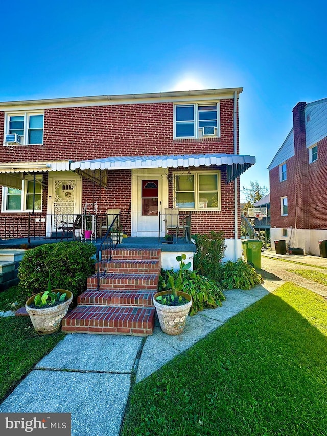 view of front of home with covered porch and a front yard