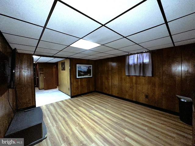 basement featuring wooden walls