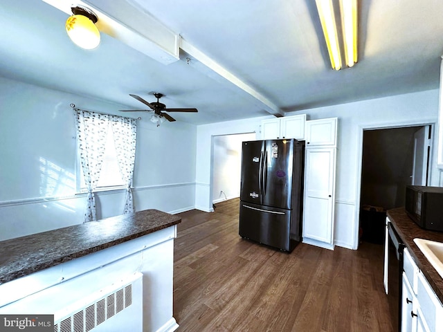 kitchen with beamed ceiling, refrigerator, white cabinetry, and dark wood-type flooring