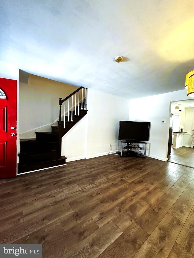 unfurnished living room with dark wood-type flooring