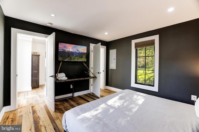 bedroom with recessed lighting, wood finished floors, and baseboards