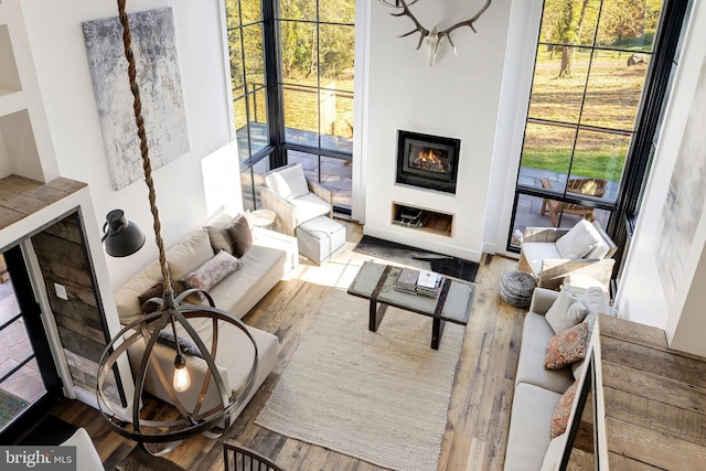 living area with a fireplace and wood finished floors