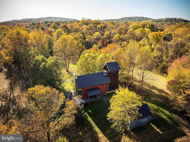 birds eye view of property with a view of trees