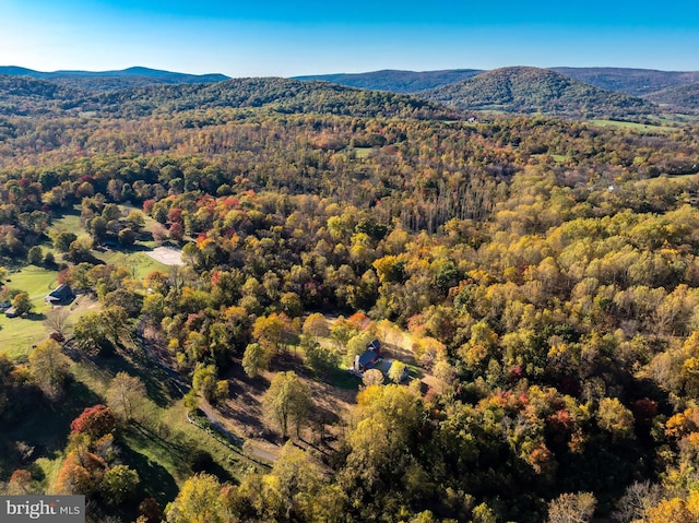 aerial view with a mountain view and a wooded view