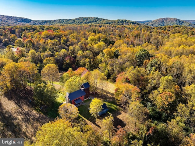 birds eye view of property with a mountain view and a forest view