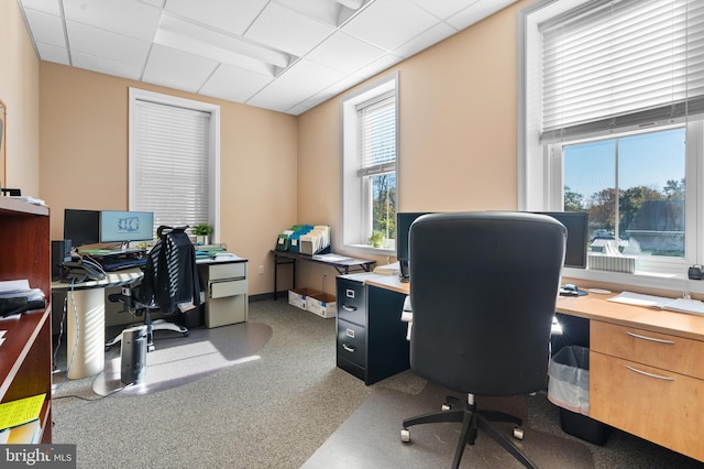 home office with a paneled ceiling and plenty of natural light