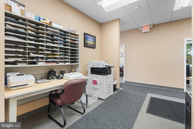 office with carpet, a drop ceiling, and built in desk