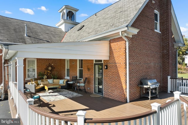 deck with grilling area and an outdoor living space