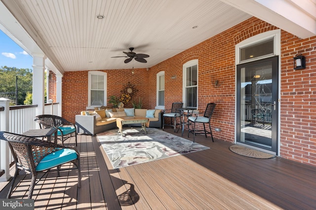 deck with outdoor lounge area and ceiling fan