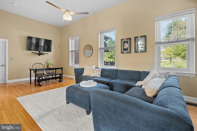 living room with hardwood / wood-style floors and ceiling fan