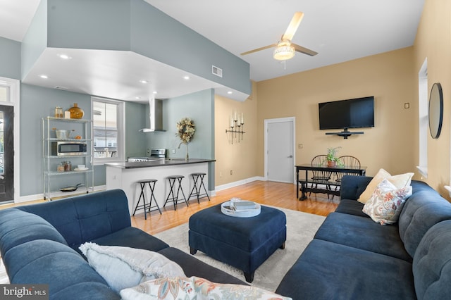 living room with ceiling fan and light hardwood / wood-style floors