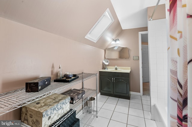 bathroom featuring lofted ceiling with skylight, tile patterned flooring, vanity, and shower / bath combination with curtain