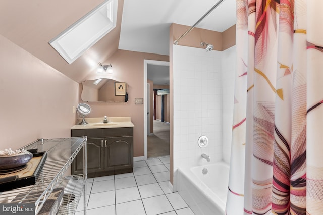 bathroom featuring tile patterned flooring, vanity, lofted ceiling with skylight, and shower / bath combo with shower curtain