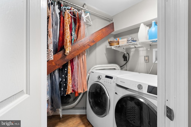 laundry room with hardwood / wood-style flooring and washer and clothes dryer