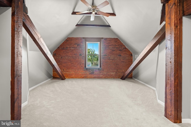 additional living space featuring ceiling fan, light carpet, brick wall, and vaulted ceiling