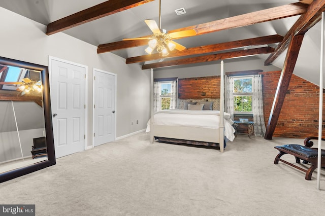 carpeted bedroom with lofted ceiling with beams, ceiling fan, and brick wall