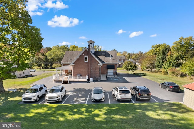 view of vehicle parking featuring a yard