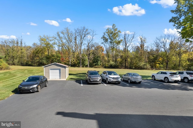 view of parking with a lawn