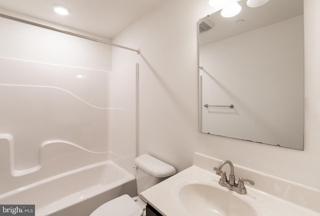 bathroom with toilet, vanity, and shower / bath combination