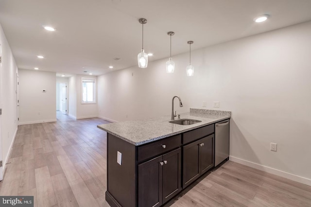 kitchen with dishwasher, sink, hanging light fixtures, light stone counters, and kitchen peninsula