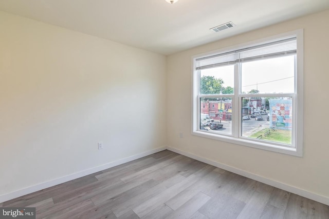 spare room with light hardwood / wood-style floors