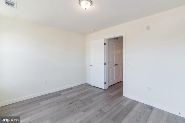 spare room with light wood-type flooring