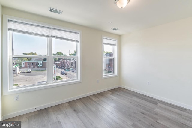 unfurnished room with light hardwood / wood-style flooring