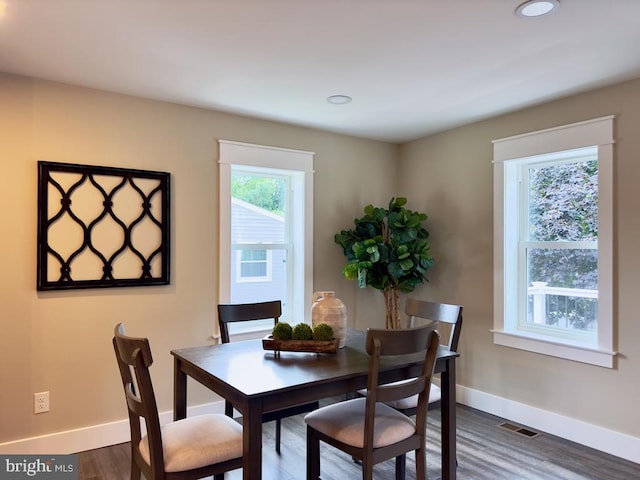 dining area with dark hardwood / wood-style floors