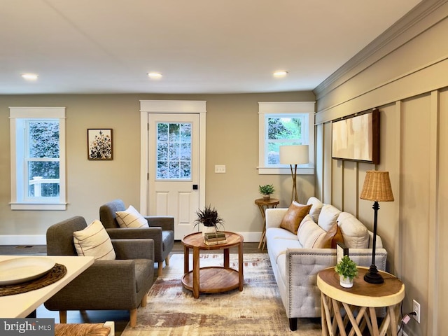 living room with light hardwood / wood-style floors and ornamental molding