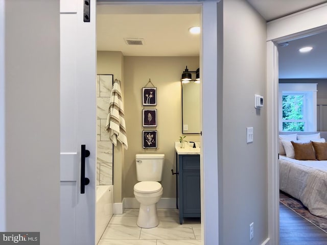 bathroom featuring toilet, hardwood / wood-style flooring, vanity, and a shower