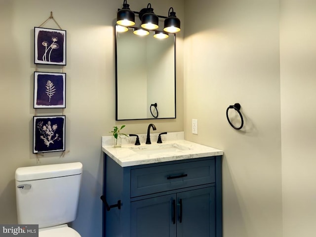 bathroom featuring toilet and vanity