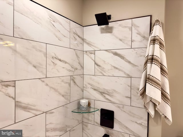 interior details with a tile shower