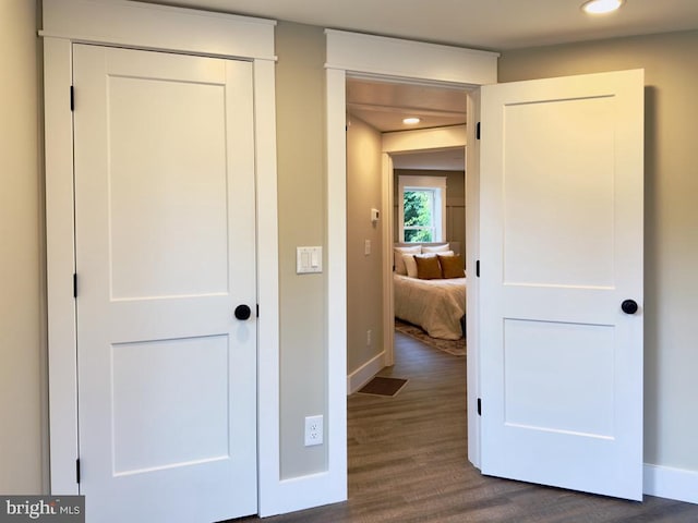 hall with dark wood-type flooring