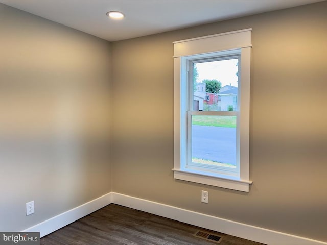 unfurnished room featuring dark hardwood / wood-style flooring