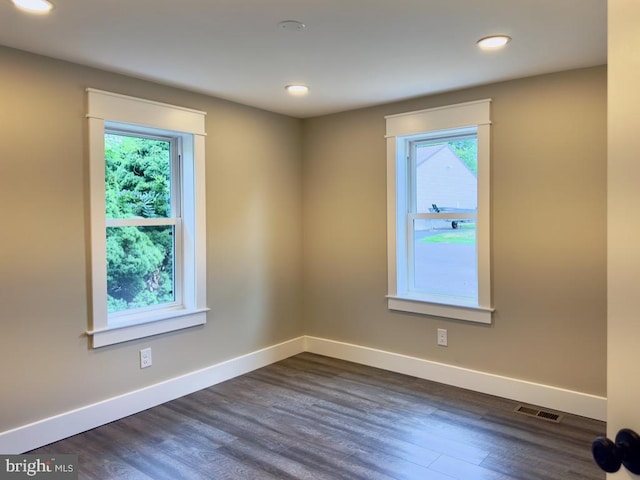 spare room featuring dark hardwood / wood-style flooring