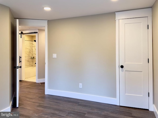 unfurnished room with dark hardwood / wood-style flooring