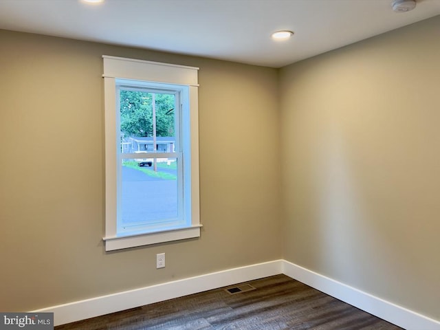 spare room featuring dark hardwood / wood-style floors