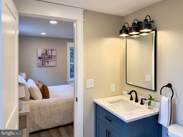 bathroom with vanity, hardwood / wood-style flooring, and toilet