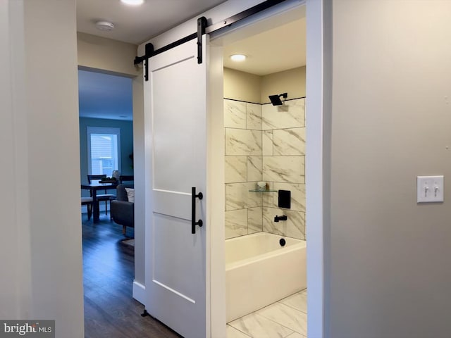 bathroom with tiled shower / bath and wood-type flooring