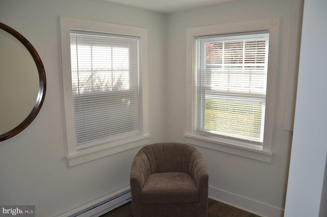 living area featuring dark wood-type flooring and a baseboard radiator