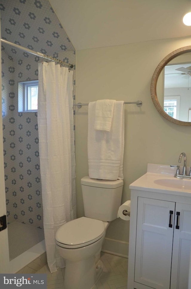 bathroom with tile patterned flooring, vanity, vaulted ceiling, and curtained shower