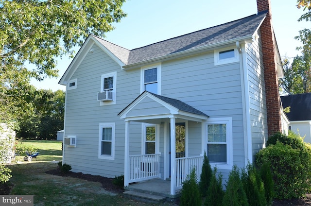 view of front of house with a front yard and cooling unit