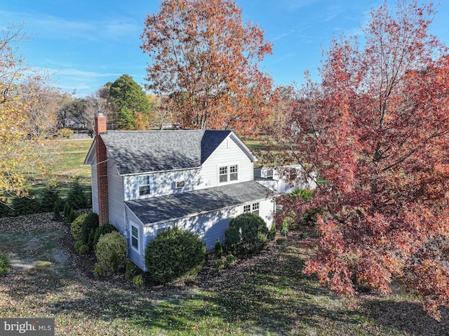 view of side of property with a lawn