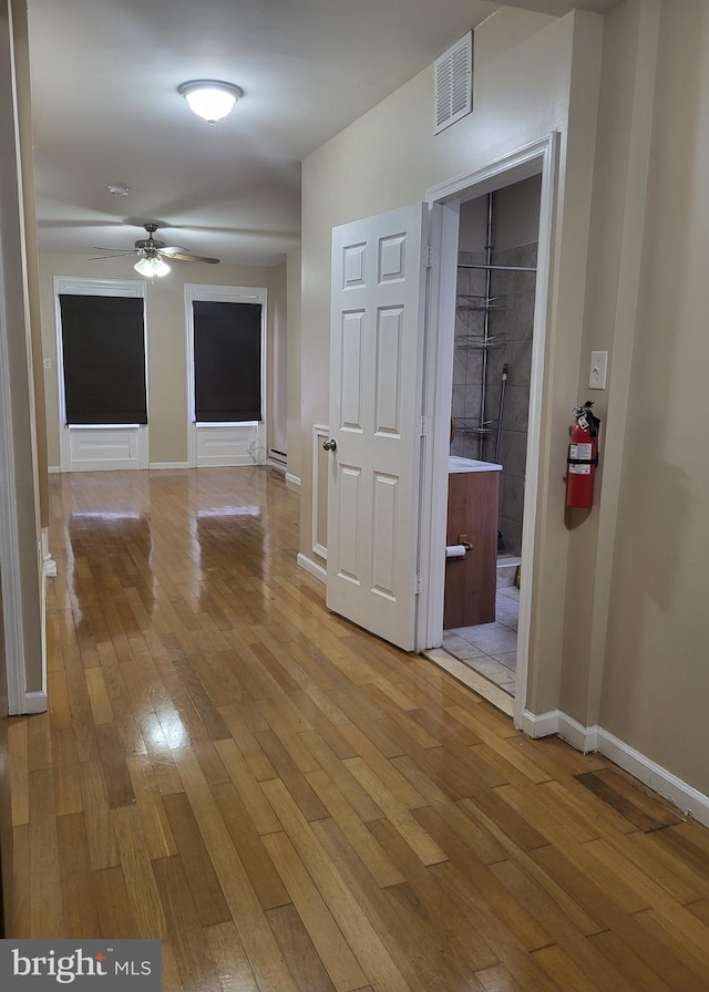 corridor with light wood-type flooring